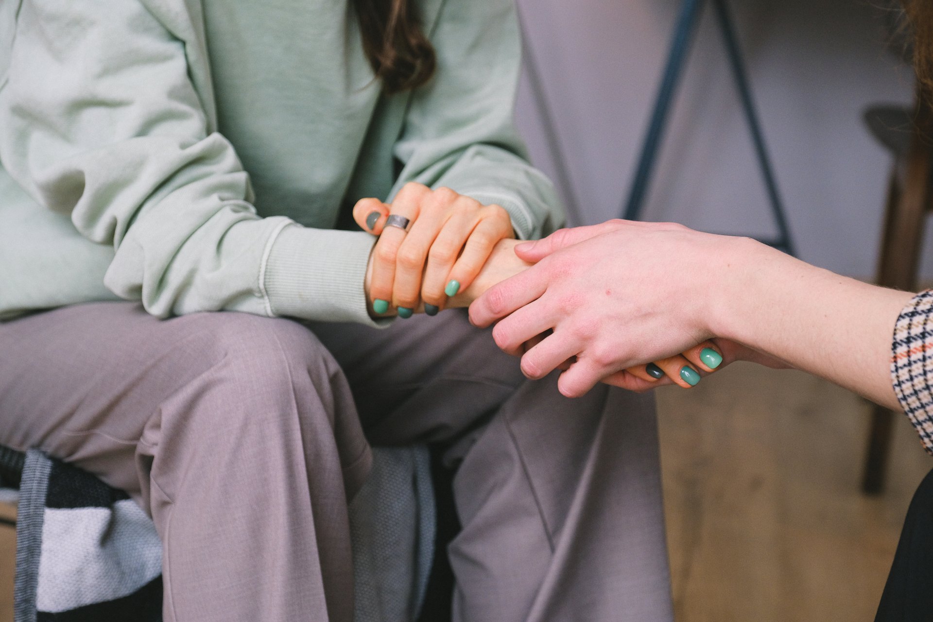 Two people holding hands in comfort