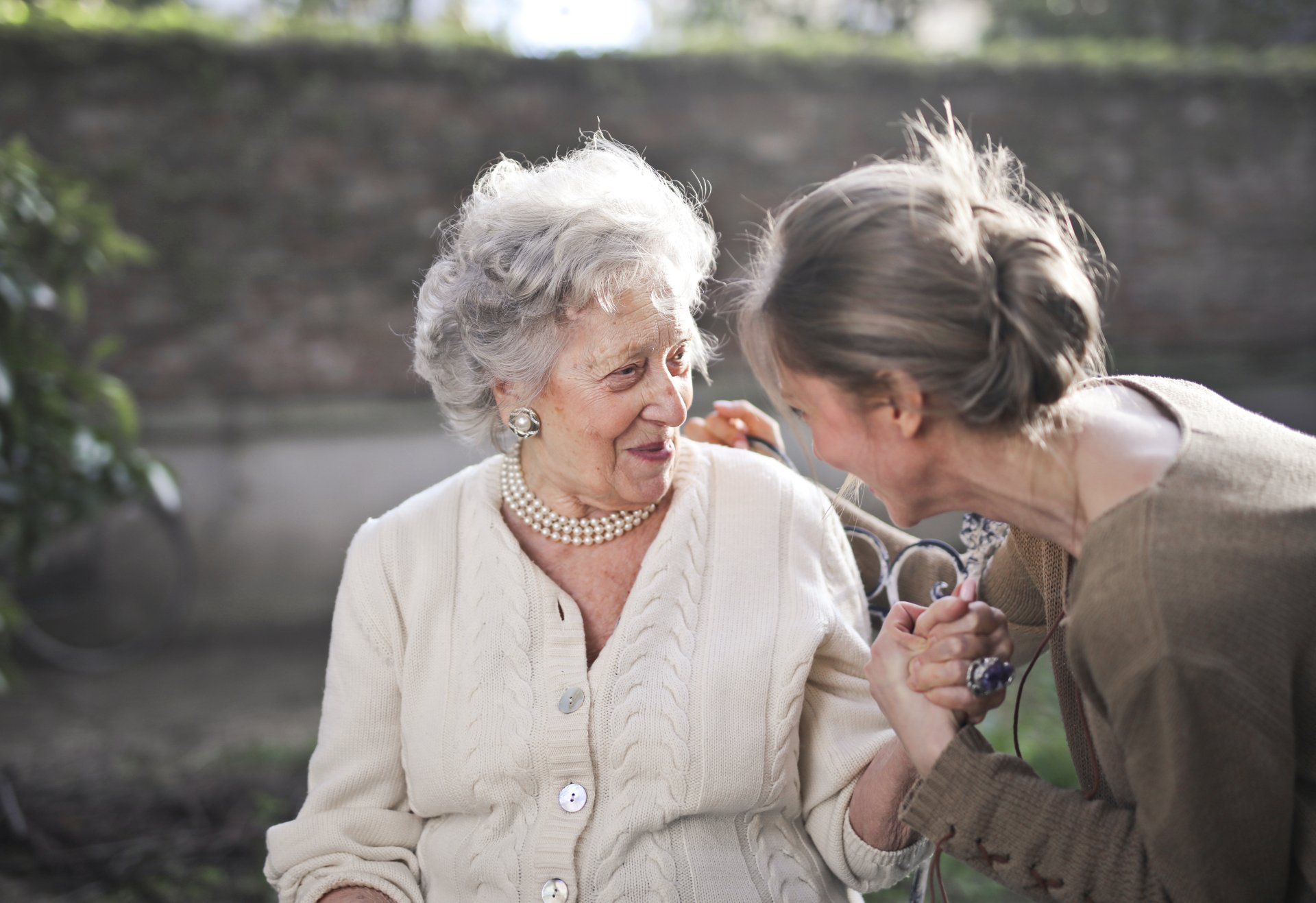 Younger woman comforting an elderly woman